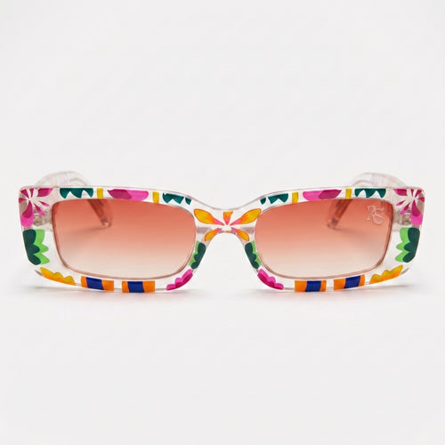 Flower Flash Sonnenbrille von Rick Shades in Frontansicht: Der schmale, rechteckige Rahmen in transparentem Rosé ist mit neonpinken Blüten, grünen und gelben Blättern sowie orangen und blauen Streifen bemalt, die Gläser haben einen lachsfarbenen Farbverlauf.